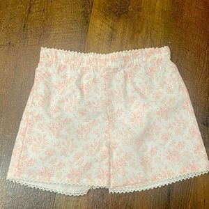 Dillards brand girls pink and cream floral shirt with lace detail. Size 5.